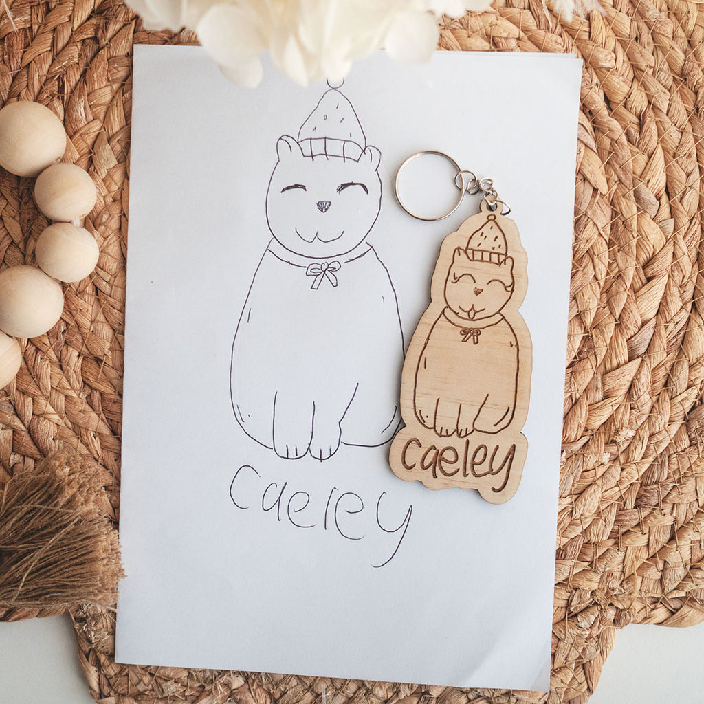 Kids drawing and handwriting bag tag. This one is a kid's drawing of a cat engraved on wood.