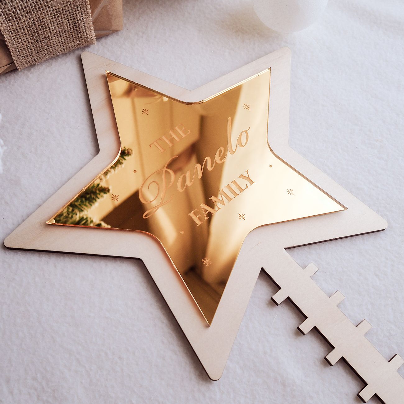 Gold star-shaped decorative item with 'Pamela Family' engraving on a light background
