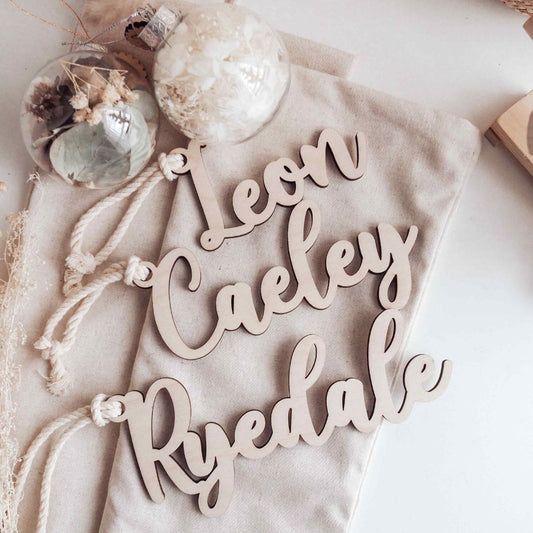 Wooden name signs on a textured surface with decorative elements