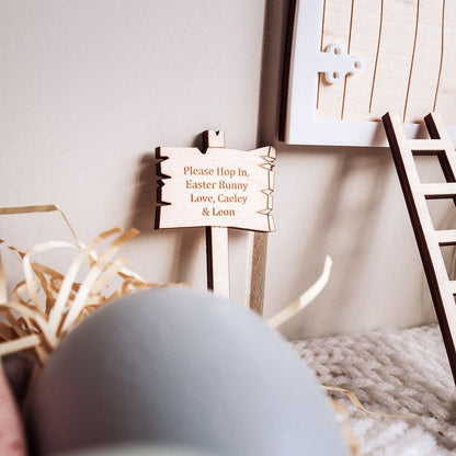 Wooden sign with personalized message on a soft surface