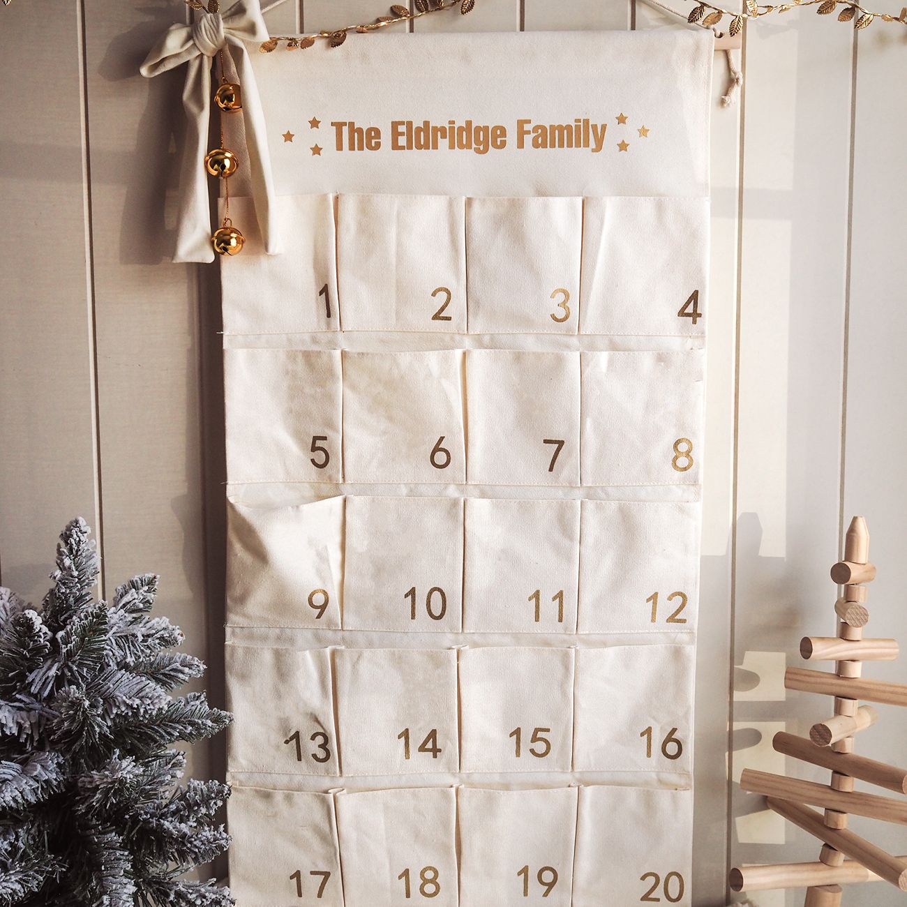 Advent calendar with 'The Eldridge Family' text, Christmas tree, and wooden decorations.