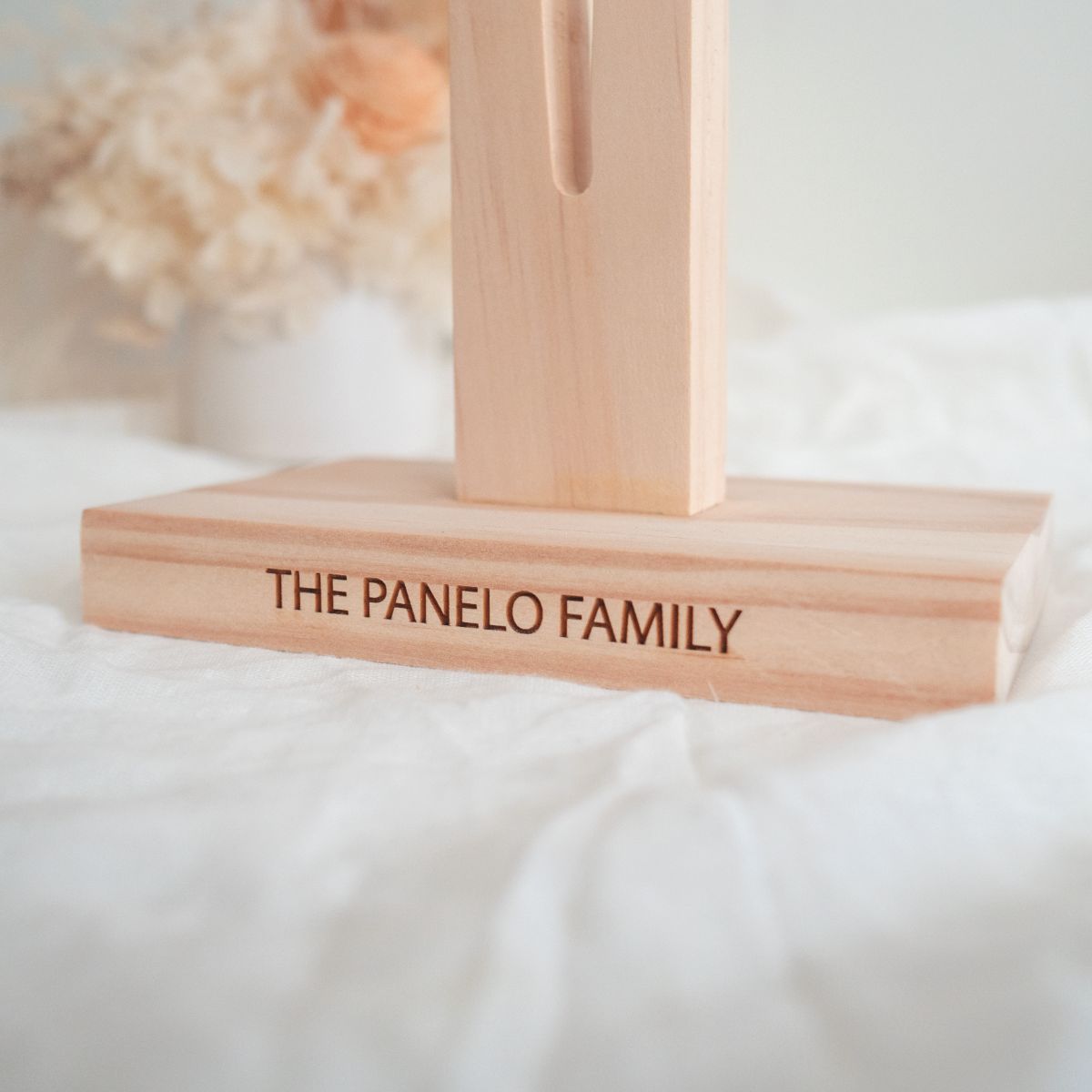 A personalised, Tasmanian oak wood cross. A closeup of the personalised text