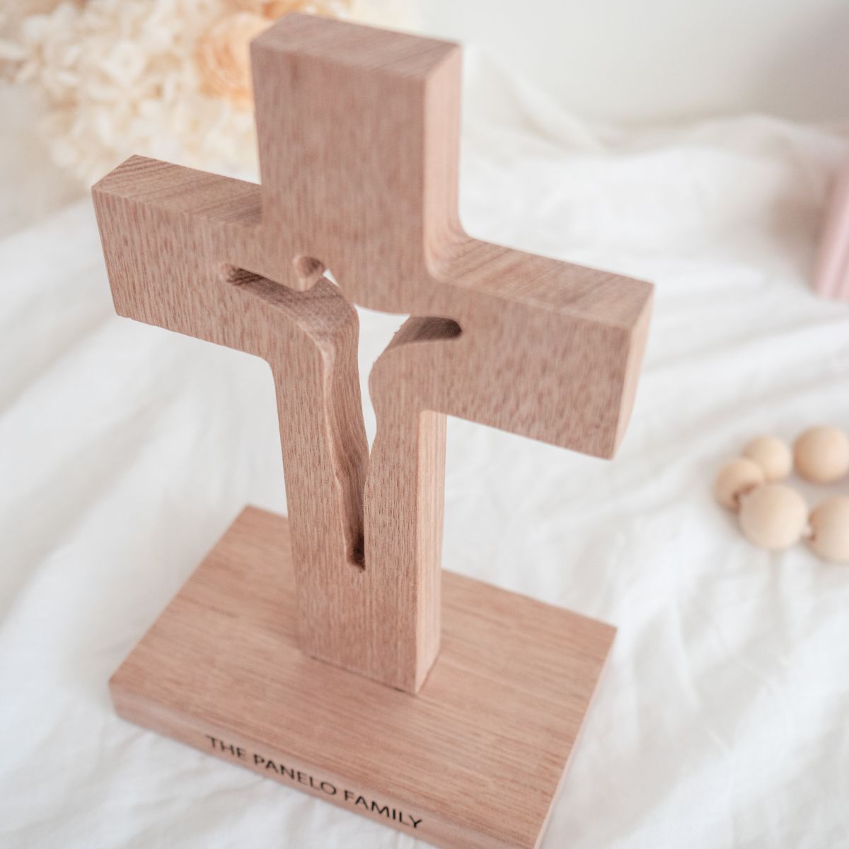 A personalised, Tasmanian oak wood cross. Jesus on cross is cut through. Top view