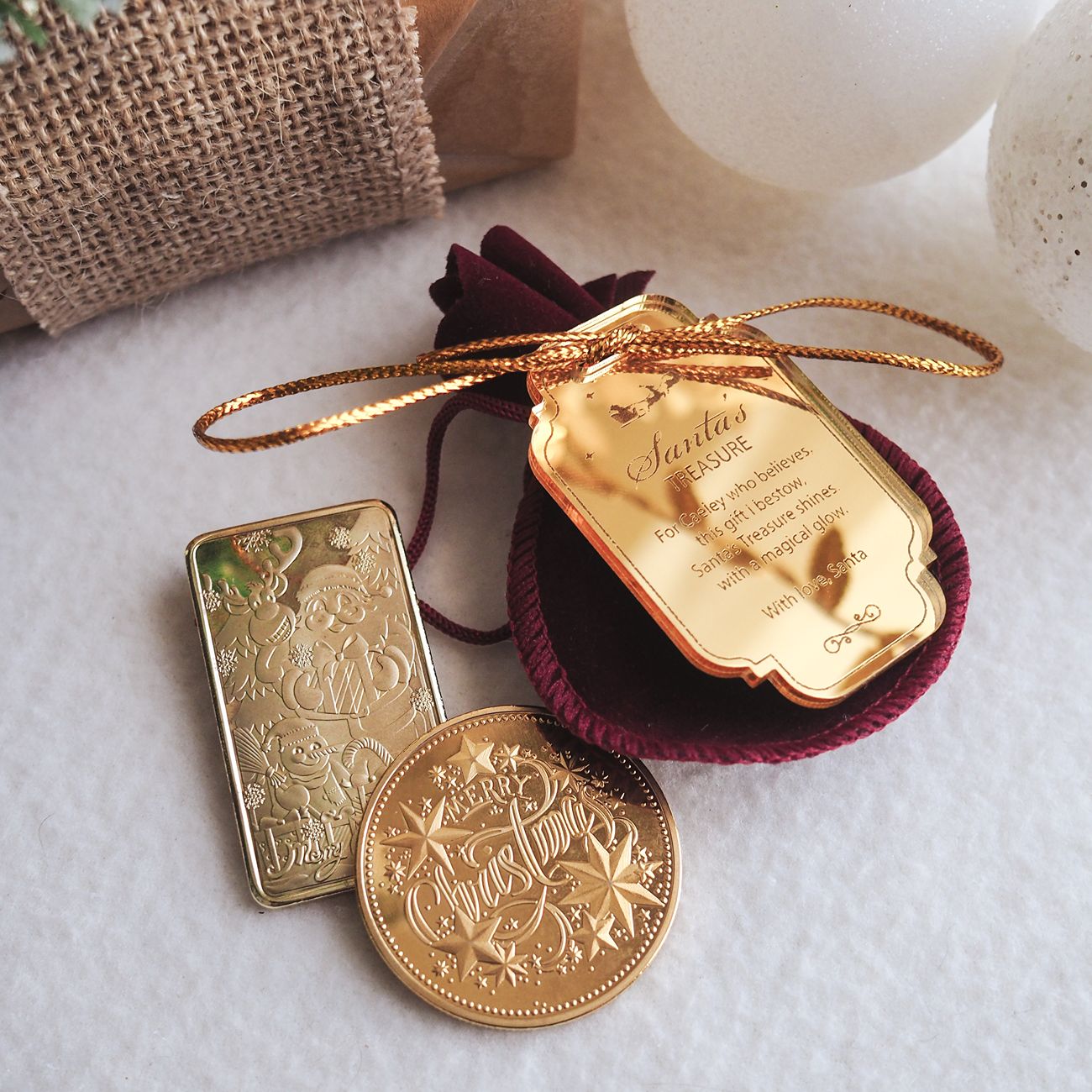 Gold bar, gold coin, and gold tag on a textured surface
