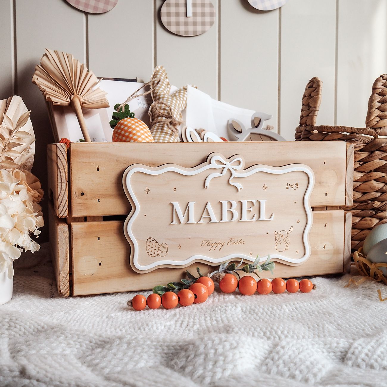 Wooden crate with 'MABEL' sign on a soft surface