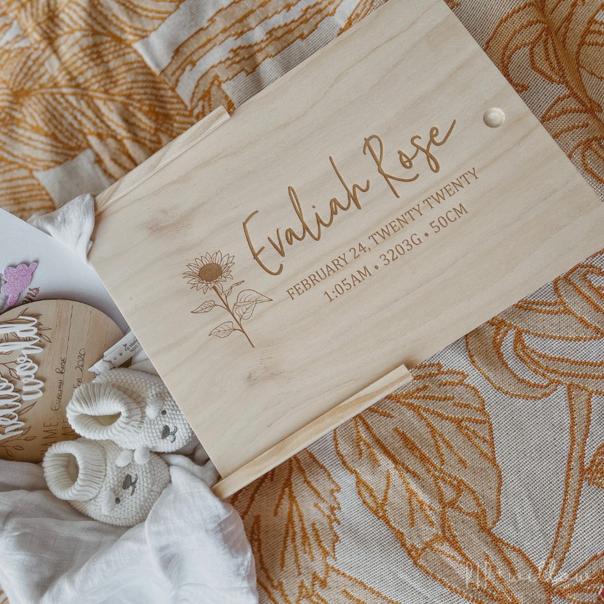 This is a large wooden baby keepsake box with a sunflower design