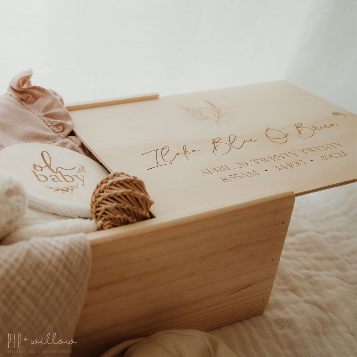 This is a large wooden baby keepsake box with a floral design shot at an angle