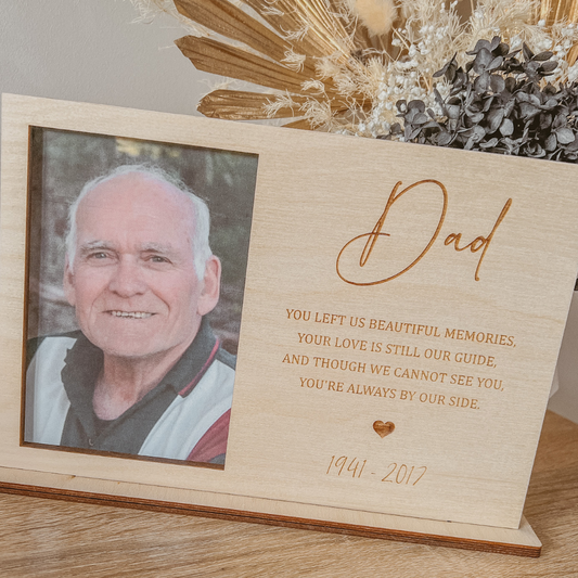 Custom wooden remembrance photo frame for Dad featuring a sentimental poem and birth-death years, displayed on a wooden table as a sympathy gift