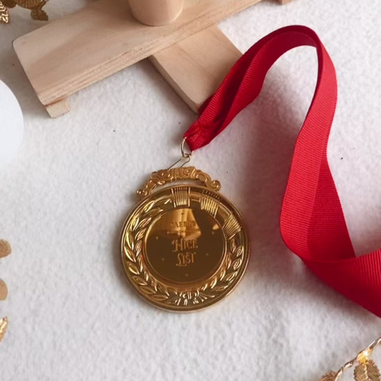 Nice List Medal in Gold with red ribbon tie