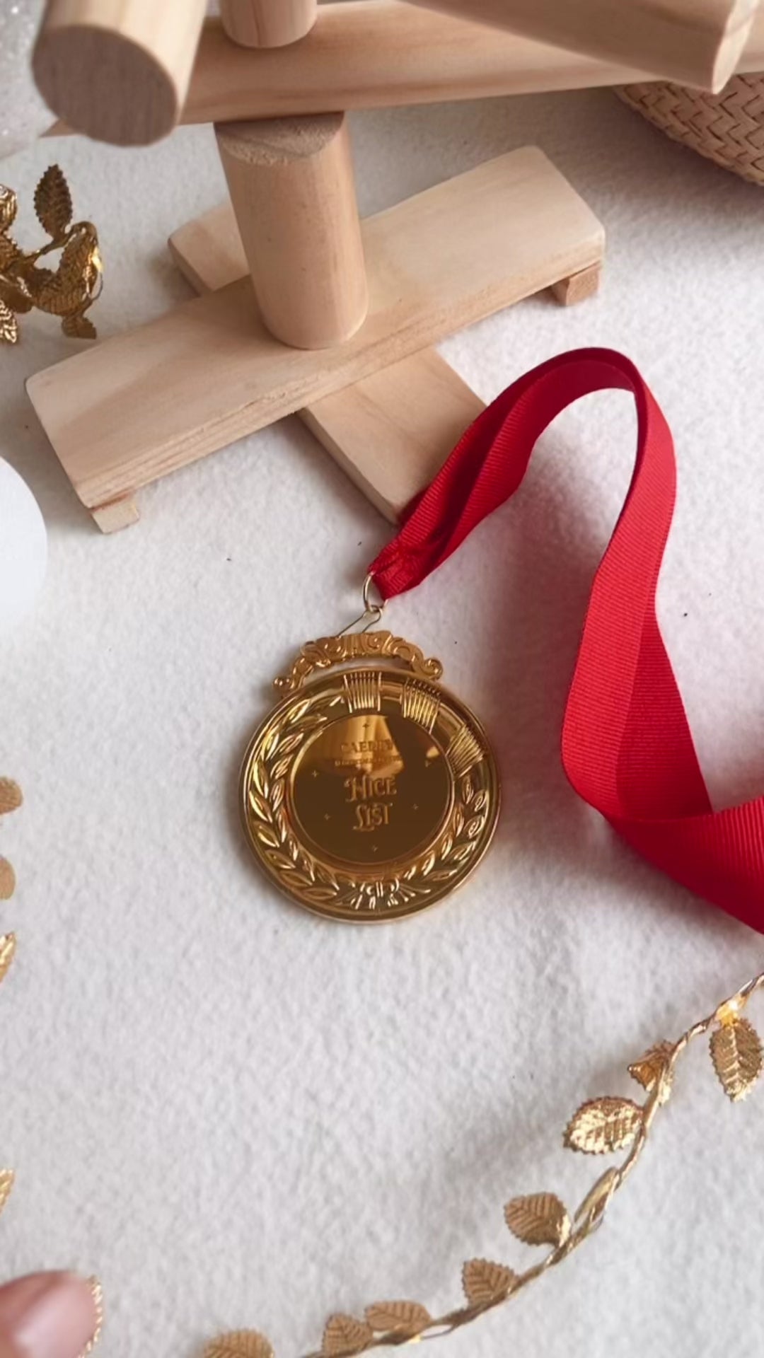 Nice List Medal in Gold with red ribbon tie